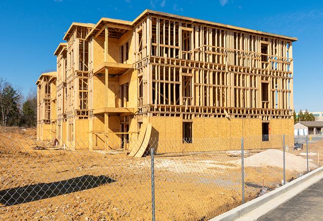 a close-up of temporary chain link fences enclosing a construction site, signaling progress in the project's development in Palmdale